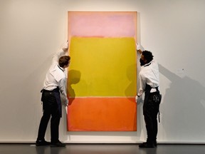 Art handlers hang Mark Rothko's "No. 7", part of The Macklowe Collection, at Sotheby's on Nov. 5, 2021 in New York City.
