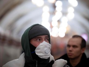 A man wearing a face mask walks at a metro station in Moscow on Nov. 22, 2021, amid the ongoing COVID-19 pandemic.