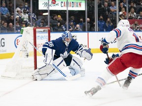 New York Rangers' Julien Gauthier rushes the net with the puck as Maple Leafs goaltender Jack Campbell positions himself during the second period at Scotiabank Arena on Thursday, Nov. 18, 2021.