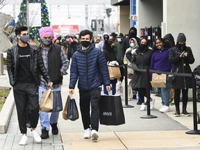 People line up at the Toronto Premium Outlets mall on Black Friday for shopping sales during the COVID-19 pandemic in Milton, Ont., Friday, Nov. 27, 2020.