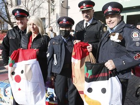 The 27th annual Toronto Police Auxiliary Toy Drive was launched at 42 Division on Milner Ave. in Scarborough on Saturday, Nov. 13, 2021. (L-R) Staff-Sgt. Gerry Heaney, Toy Drive founder and retired Auxiliary Sgt. Carrie Malin, auxiliary officer Fanny Lau, Chief James Ramer and auxiliary officer Rick Jordan.