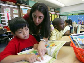 Yael Kalban, a Yale graduate, with her second graders Juan Mena, left, and Jyquone Teal, both 7 years old in her classroom at a school in the Bronx on Friday, Sept. 30, 2005.