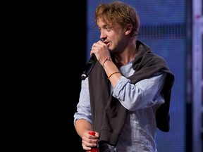 Tom Felton, who played Draco Malfoy in the Harry Potter flims, walks on stage for a panel discussion during the Calgary Comic and Entertainment Expo at Stampede Park in Calgary, Alta., on Sunday, May 1, 2016.