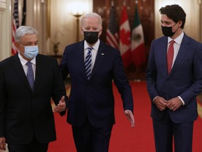 U.S. President Joe Biden (centre), Canadian Prime Minister Justin Trudeau (right) and Mexican President Andres Manuel Lopez Obrador enter the East Room for a North American Leaders’ Summit (NALS) at the White House on Nov. 18, 2021 in Washington.