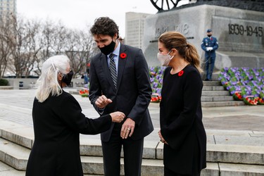 National Silver Cross Mother Debbie Sullivan speaks with Prime Minister Justin Trudeau and his wife Sophie Gregoire following a ceremony at the National War Memorial on Remembrance Day in Ottawa, Nov. 11, 2020.