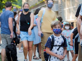 A child wears a face mask on the first day of New York City schools, amid the COVID-19 pandemic in Brooklyn, New York, Sept. 13, 2021.