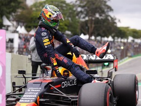Red Bull's Dutch driver Max Verstappen gets out of his cockpit after taking the second place in the qualifying session for Brazil's Formula One Sao Paulo Grand Prix in Sao Paulo, on November 12, 2021.
