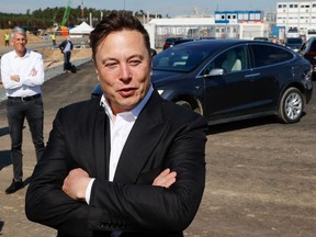 Tesla CEO Elon Musk talks to media as he arrives to visit the construction site of the future US electric car giant Tesla, on September 03, 2020 in Gruenheide near Berlin.