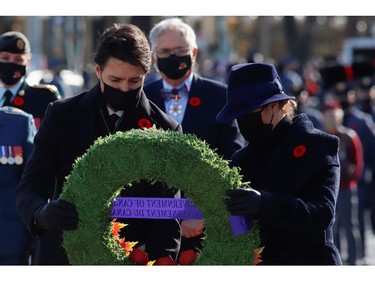Prime Minister Justin Trudeau and his wife Sophie Gregoire lay a wreath during a ceremony at the National War Memorial on Remembrance Day in Ottawa, Nov. 11, 2021.