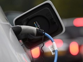 An  electric car is charged at a roadside EV charge point in London, England,  on Oct. 19, 2021. Toby