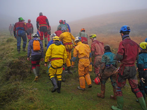 Rescuers walk Monday toward the Ogof Ffynnon Ddu cave system in Wales.