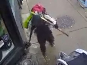 Store security video captured images of a man spraying an unknown substance into a community water bowl for dogs outside Spiritleaf cannibas shop on Queen St. E.