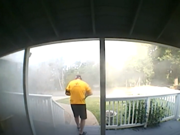  Man seen through doorbell camera rescuing pets from house on fire. (WTHR)