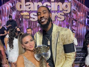 Iman Shumpert and Daniella Karagach are pictured with the Mirrorball Trophy.
