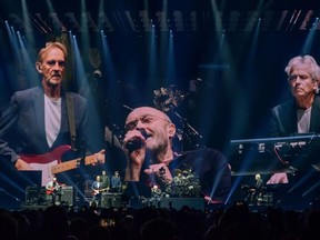 CHICAGO, ILLINOIS --  Mike Rutherford (L), Phil Collins (C), and Tony Banks (R), of Genesis, perform on the opening night of their North American "The Last Domino?" tour at Chicago's United Center on Nov. 15, 2021.