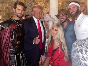 Paulina Gretzky, front in Baywatch red, and beau Dustin Johnson, far right, celebrate Halloween with Donald Trump.