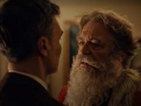Santa Claus and man about to kiss in ad for Norways postal service.