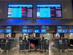 Digital display boards show cancelled flights to London - Heathrow at O.R. Tambo International Airport in Johannesburg, South Africa, November 26, 2021.