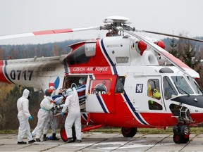 Medical workers transport a coronavirus disease (COVID-19) patient, who is being transferred from a Brno hospital by a Czech Air Force helicopter, in Prague, Czech Republic, November 25, 2021.