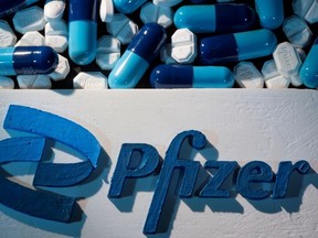 A 3D printed Pfizer logo is placed near medicines from the same manufacturer in this illustration taken Sept. 29, 2021.