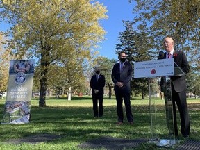 Steve Clark, provincial minister of municipal affairs and housing, speaks Wednesday, Nov. 10, 2021 at an announcement about a tiny homes development for homeless veterans in Kingston while David Howard of Homes for Heroes and Mayor Bryan Paterson listen.