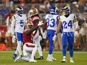 49ers wide receiver Deebo Samuel celebrates in front of Rams free safety Taylor Rapp (24), safety Nick Scott (33) and cornerback Jalen Ramsey (5) after picking up a first down during NFL action at Levi's Stadium in Santa Clara, Calif., Monday, Nov. 15, 2021.