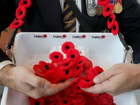 Montgomery Legion veteran Robert Juteau with poppies at the Billings Bridge Shopping Centre in Ottawa Tuesday, Nov. 2, 2021.