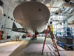 The United Boeing 247D gets a wipe-down by staff before being raised in the America by Air Gallery 102 at the Smithsonian National Air and Space Museum on Aug. 17.