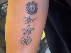 A screenshot from TikTok of Emily McNeil's tattoos.