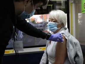 A woman gets her latest COVID-19 vaccine dose at a mobile clinic on Nov.  1, 2021 in Petrolia, Ont.