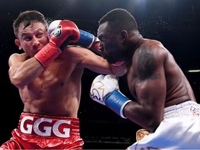 Gennady Golovkin of Kazakhstan (red trunks) trades punches with Steve Rolls of Canada (white trunks) during their Super Middleweights fight at Madison Square Garden on June 08, 2019 in New York City.