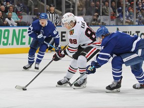 Maple Leafs defenceman Justin Holl moves over to try and slow down Blackhawks' Patrick Kane  during Saturday's %-4 win for Toronto.