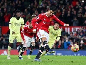 Cristiano Ronaldo of Manchester United scores their side's third goal from the penalty spot during the Premier League match between Manchester United and Arsenal at Old Trafford on December 02, 2021 in Manchester, England.