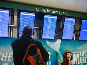 A traveller checks arrivals and departures flight information at George Bush Intercontinental Airport on December 03, 2021 in Houston, Texas.