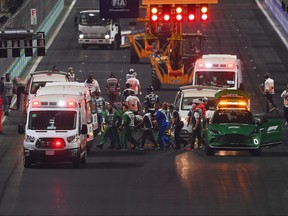 Theo Pourchaire of France and ART Grand Prix and Enzo Fittipaldi of Brazil and Charouz Racing System receive medical treatment after a crash at the start during the feature race of Round 7:Jeddah of the Formula 2 Championship at Jeddah Corniche Circuit on Dec. 5, 2021 in Jeddah, Saudi Arabia.