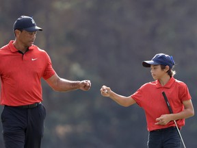 Tiger Woods and Charlie Woods celebrate a birdie on the 13th hole during the final round of the PNC Championship at the Ritz Carlton Golf Club Grande Lakes on December 19, 2021 in Orlando, Florida.