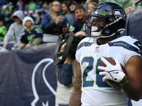 Rashaad Penny of the Seattle Seahawks reacts after scoring a touchdown against the Houston Texans.