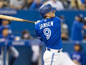 Danny Jansen of the Toronto Blue Jays hits a home run against the Baltimore Orioles.