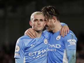 Manchester City's Phil Foden (left) and Jack Grealish celebrate after the match against Brentford.