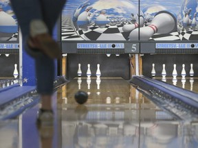 A bowler tries to knock down pins at Streetsville Bowl on Dec. 19, 2021.