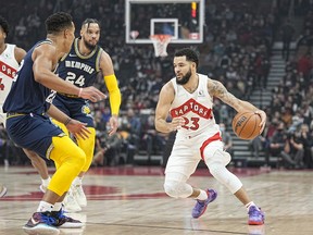 Toronto Raptors guard Fred VanVleet (23) drives to the net against Memphis Grizzlies guard Desmond Bane (22) and forward Dillon Brooks (24) during the first quarter at Scotiabank Arena.
