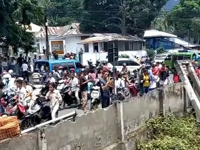 A still image from a social media video shows people on a street after an earthquake in Maumere, East Nusa Tenggara, Indonesia, Dec. 14, 2021.