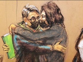 Jeffrey Epstein associate Ghislaine Maxwell embraces her defence attorney Bobbi Sternheim as she enters the courtroom to hear a note from the jury in a courtroom sketch in New York City, Dec. 21, 2021.