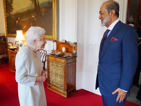 Queen Elizabeth greets the Sultan of Oman, Sultan Haitham bin Tariq,  during an audience at Windsor Castle on December 15, 2021.