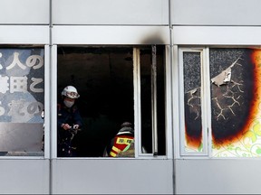 Firefighters work at the scene, where 27 people were feared dead after a blaze at a building in Osaka, on Dec. 17, 2021.