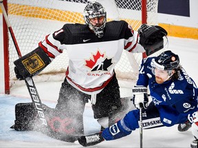 Finland’s forward Markus Granlund (right) attacks Canada’s goalie Justin Pogge during the Channel One Cup of the Euro Hockey Tour ice hockey match between Canada and Finland at CSKA Arena in Moscow last week. Pogge might get a chance to play for Canada at the Olympics.