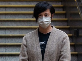 Pro-democracy activist and singer Denise Ho, a former board member of Stand News, leaves Western Police Station after being released from custody in Hong Kong on December 30, 2021, following her arrest the day before along with six other current and former staff members by the local media under British colonial law 