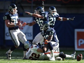 From 2001 to ’08, both linebacker Mike O’Shea (left) and defensive back Orlondo Steinauer (21) were key members of the Argonauts defence. On Sunday, they’ll square off in the 108th Grey Cup game.