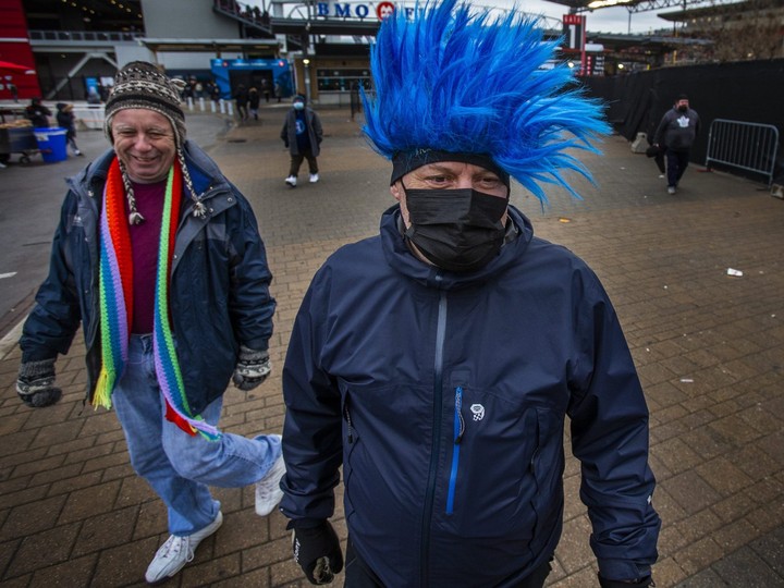  Toronto fans Dave Waters (blue hair) and Derek Ball leave BMO Field on Sunday. Ernest Doroszuk/Toronto Sun/Postmedia