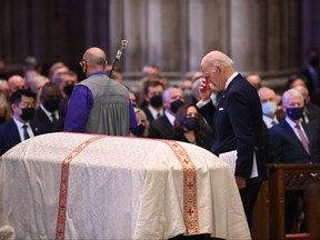 U.S. President Joe Biden reacts as the casket departs during the funeral service for late U.S. Senator Bob Dole at the Washington National Cathedral on Dec. 10, 2021, in Washington, D.C.